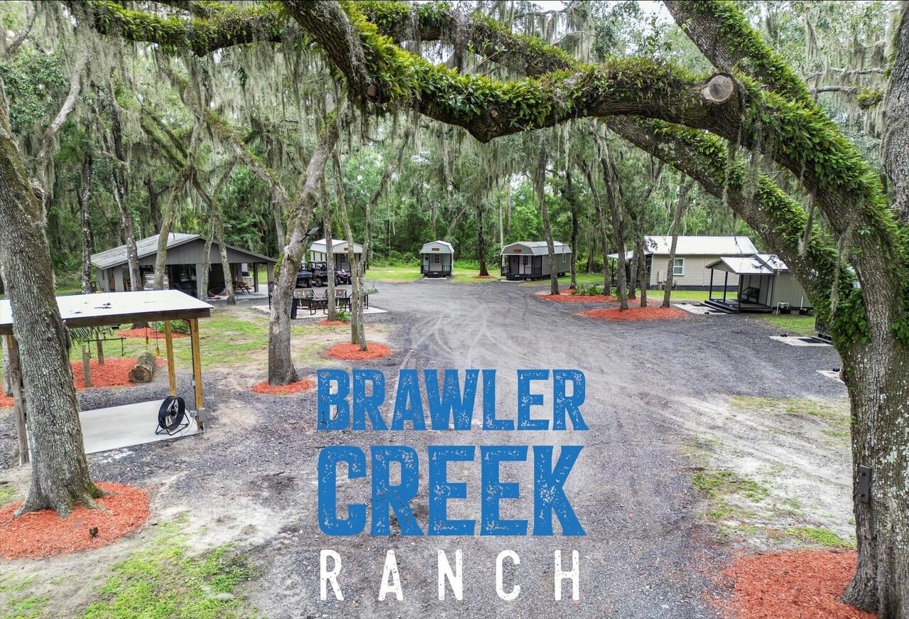 Aerial view of the cabins and grounds at Brawler Creek Ranch under the oaks